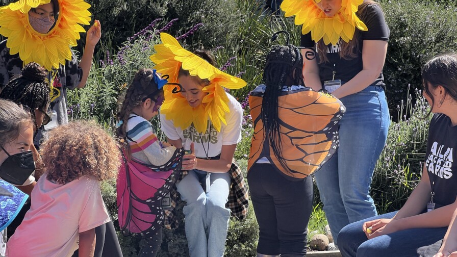 Alma Backyard Farms PodSquad work with kids in the Peas in a Pod program. 