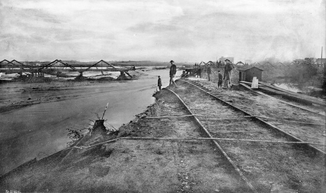 In 1886, the river washed out the adjacent tracks of the Santa Fe Railroad. The Downey Avenue Bridge, visible in the background, was also destroyed. Courtesy of the Title Insurance and Trust / C.C. Pierce Photography Collection, USC Libraries.