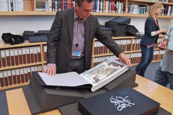 Rare book curator for the Getty Research Institute,  David Brafman, cracking open "L.A. Liber Amicorum." | Photo: Ed Fuentes.