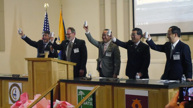 Mayor Inscore leading a toast with sake from Rikuzentakata