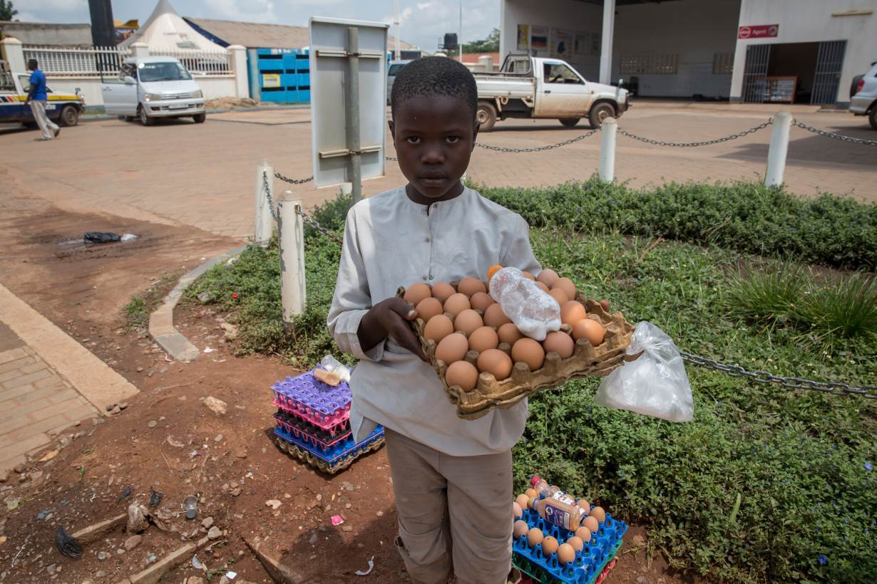 Moses, 10, sells eggs outside a petrol station to support his family. Child rights organisations say they are seeing a rise in child labour during the coronavirus pandemic. Photo taken on June 22, 2020, in Gulu, northern Uganda. Sally Hayden/Thomson Reute