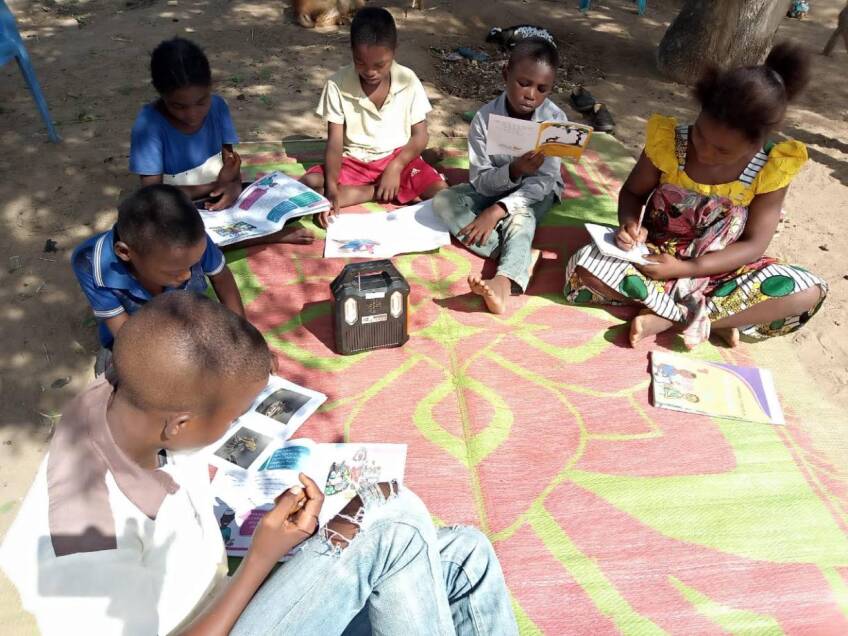 Pupils listen to school lessons broadcast over a solar radio in Dalu village, Tana River County, Kenya, November 28, 2020. Thomson Reuters Foundation | Benson Rioba