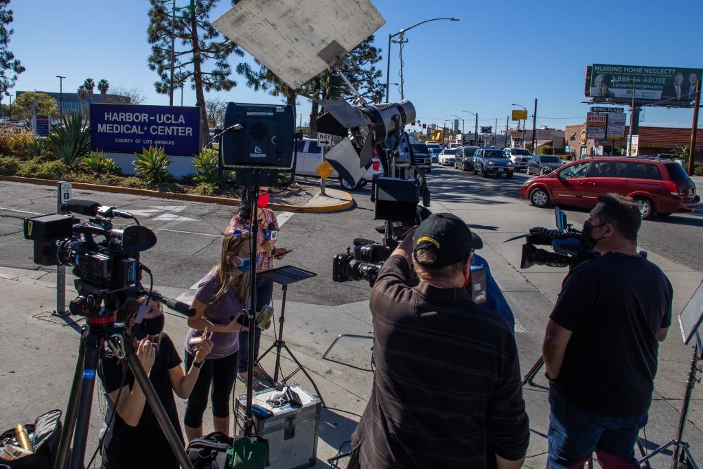 Media reporters gather by the main entrance of the Harbor UCLA Medical Center in Torrance, California on February 23, 2021.