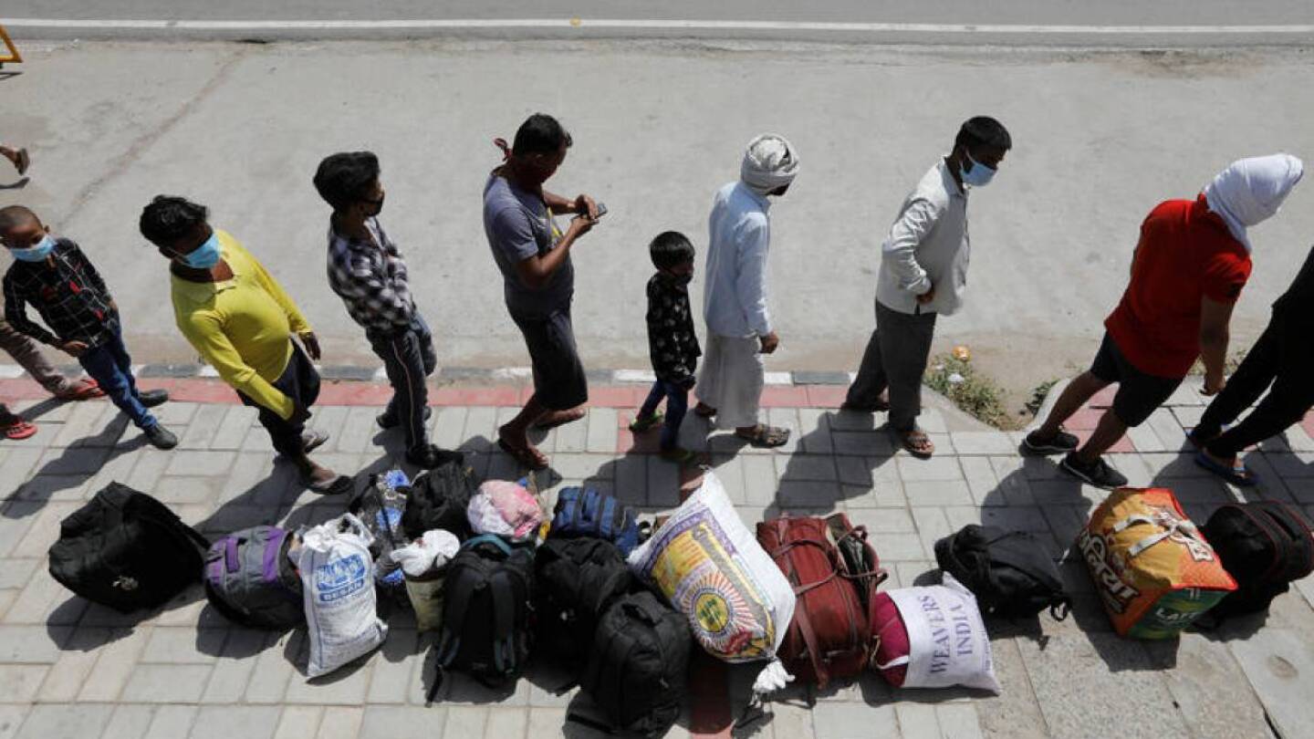 Photo from above of people waiting in line on a sidewalk.