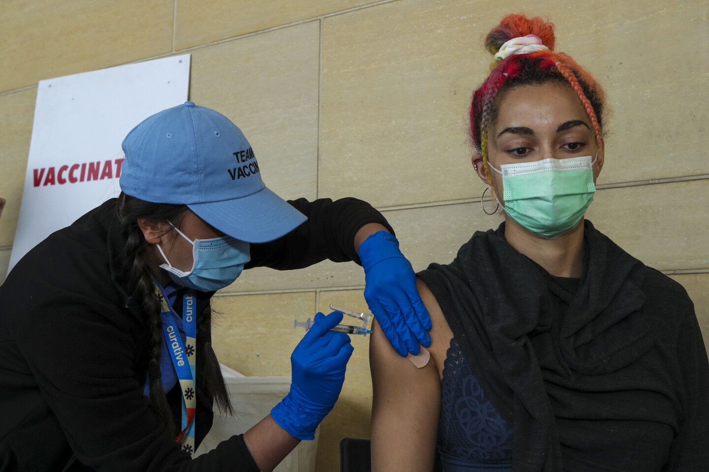 Thu Giang, a LVN, left, administers a Pfizer vaccine to Sibelle Yuksek, at newly inaugurated vaccine site at Union Station on Tuesday, June 8, 2021 in Los Angeles, CA.