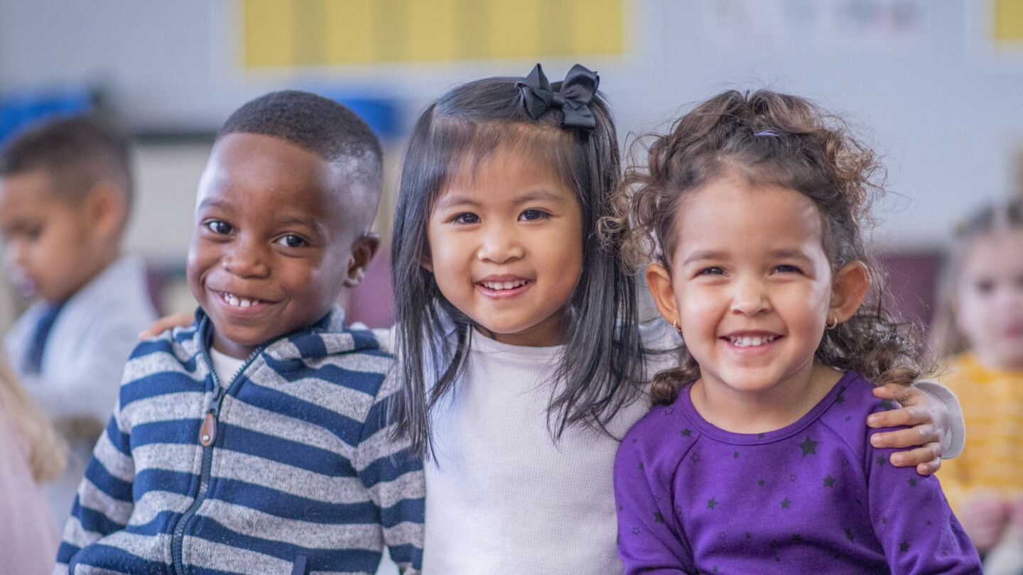 three small children sitting together