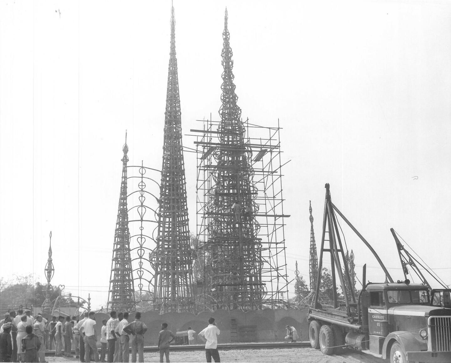 A crowd watches structural testing of the Watts Towers, July 1959