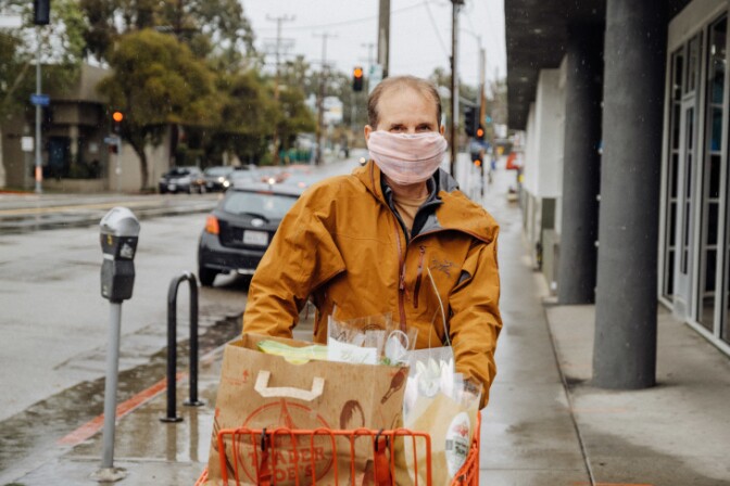 George Cook from Silverlake is used to communicating with a mask on since he's been going to Burning Man for years. He tries to give people their distance when he greets them. | Chava Sanchez/LAist