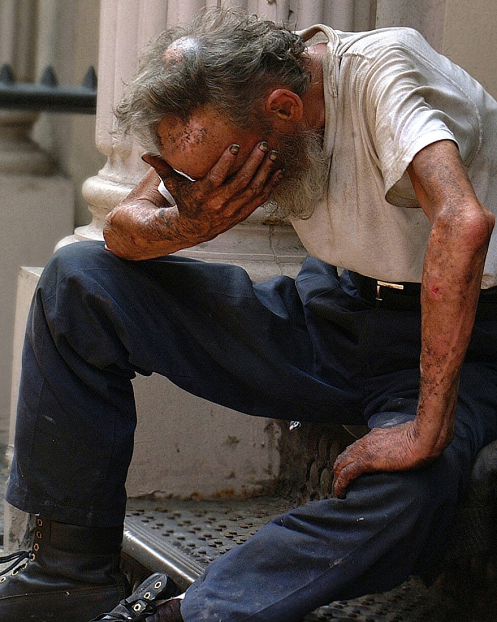A homeless man sitting on a stoop | Ben Hershey / Unsplash