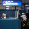 ARCHIVE PICTURE: An officer of the Tunisian State Border Guard Service wearing a protective mask checks the passport of a passenger, as a precautionary measure to avoid contracting coronavirus work at Tunisia Airport in Tunis, Tunisia February 29, 2020. REUTERS/Zoubeir Souissi