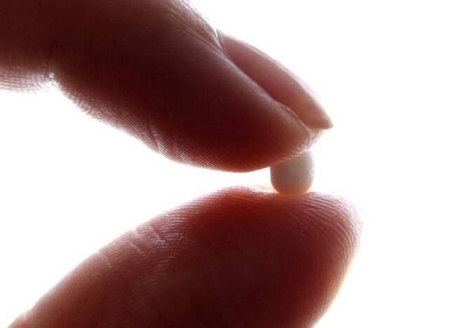 ARCHIVE PHOTO: An illustration picture shows a woman holding a birth control pill at her home in Nice January 3, 2013. | REUTERS/Eric Gaillard