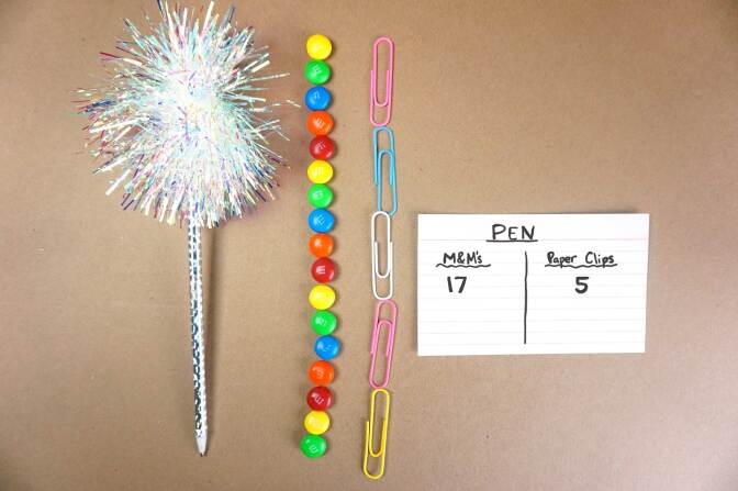 A sparkly pen’s length is measured in clips and M&M’s.