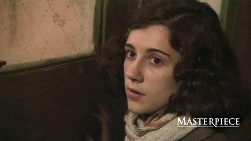 A young woman portrays Anne Frank