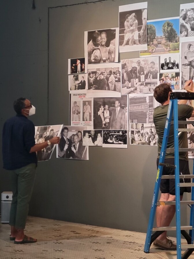 Two people put together a collage showing Muhammad Ali