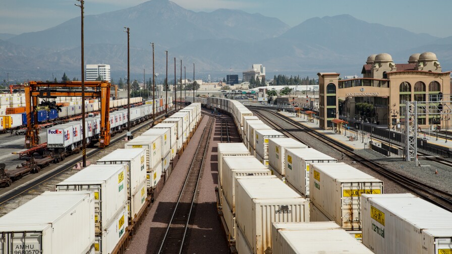 Well cars carrying shipping containers line the rails of the BNSF intermodal facility in San Bernardino, California.