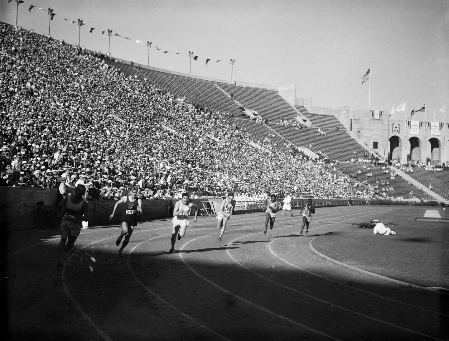Men running on a track at the 1932 Olympics in Los Angeles.