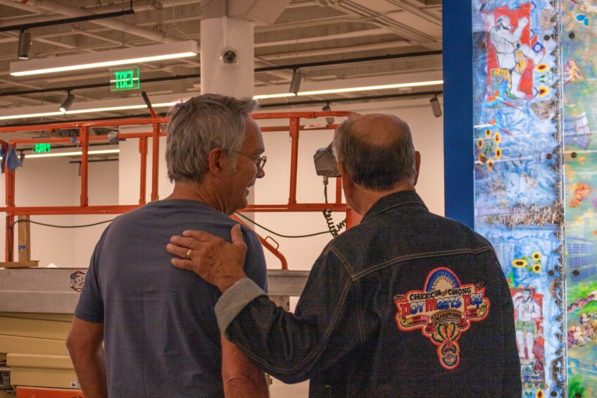 Two men looking at artwork