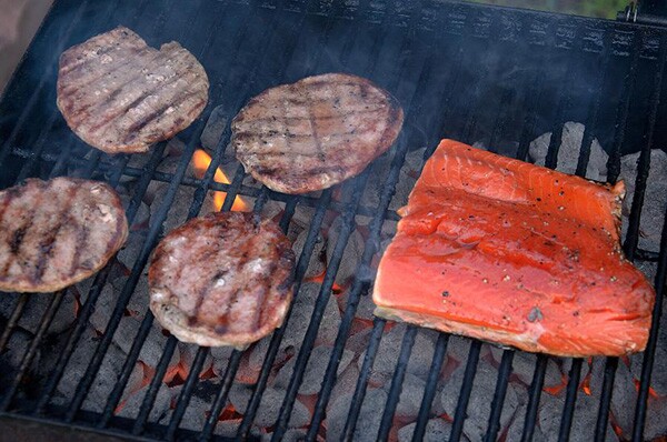 A hunk of salmon with some burger patties at the after party