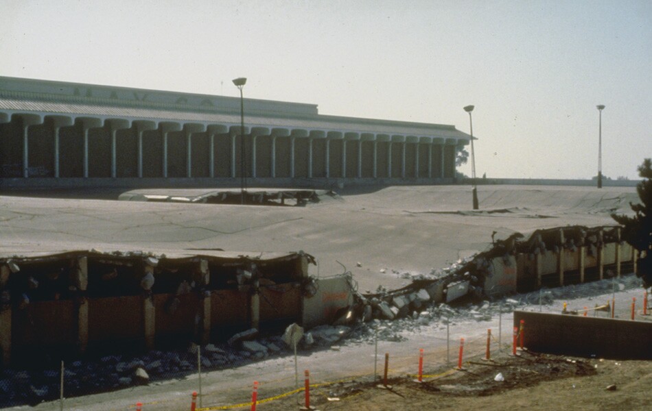 A collapsed three-story parking structure