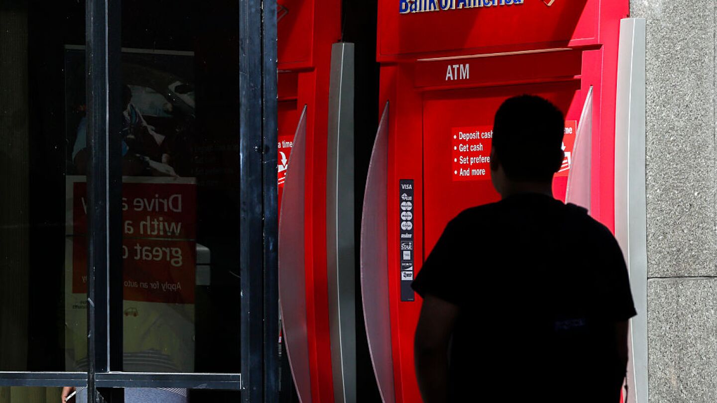 A man walks near a Bank of America Corp. ATM in Los Angeles, California, U.S., on Monday, July 13, 2015.