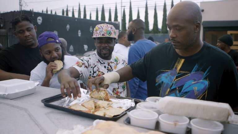 Community members celebrate "Hood Day" eating turkey tacos at Locol. | Still from "Broken Bread"