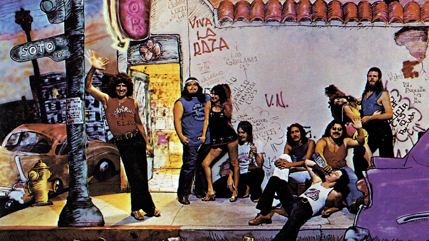 An illustration of a street corner in Los Angeles with men and women hanging out. On the side, there is graffiti that says "Viva La Raza." The album title is "Ruben and the Jets."