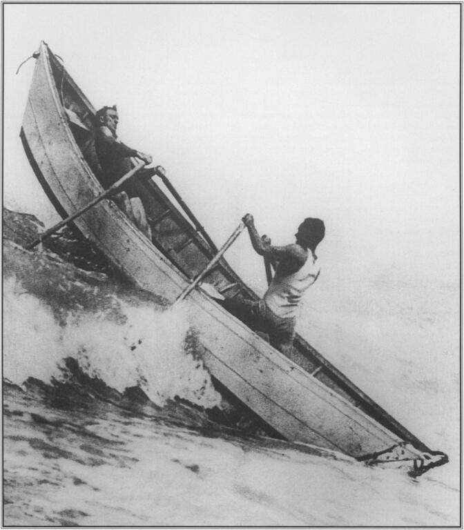 A consummate waterman, George Freeth at the bow, leaning into the effort, enjoyed rowing a quarter-ton dory through the surf to maintain his physical conditioning. With him is a fellow lifeguard at Redondo Beach in 1913. Courtesy Los Angeles County Life