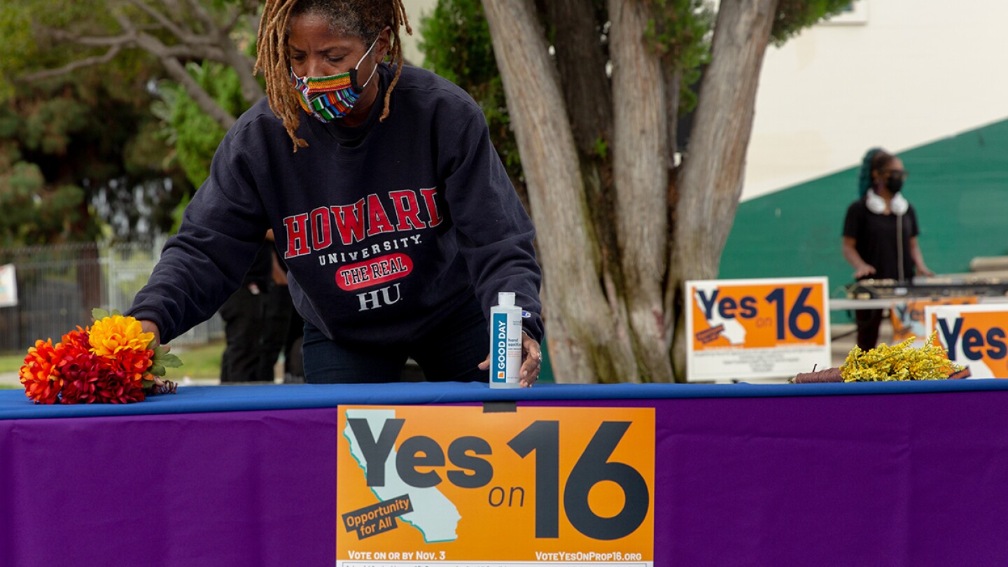Apryl Sims sets up in support of a Proposition 16 rally at Dorsey High School in Los Angeles | Allison Zaucha for The Washington Post via Getty Images