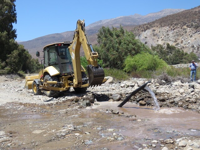 The government of Petorca and water defender organization MODATIMA unearthed a hidden pipeline syphoning water away from the river for a large plantation nearby. | Courtesy of Municipalidad de Petorca