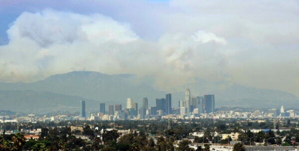 A wide plume of smoke from wildfires burning in the Angeles National Forest is seen from downtown Los Angeles during the Station Fire | Photo by Kevork Djansezian/Getty Images