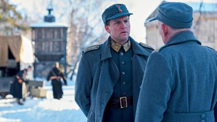 An officer speaks to a civilian.