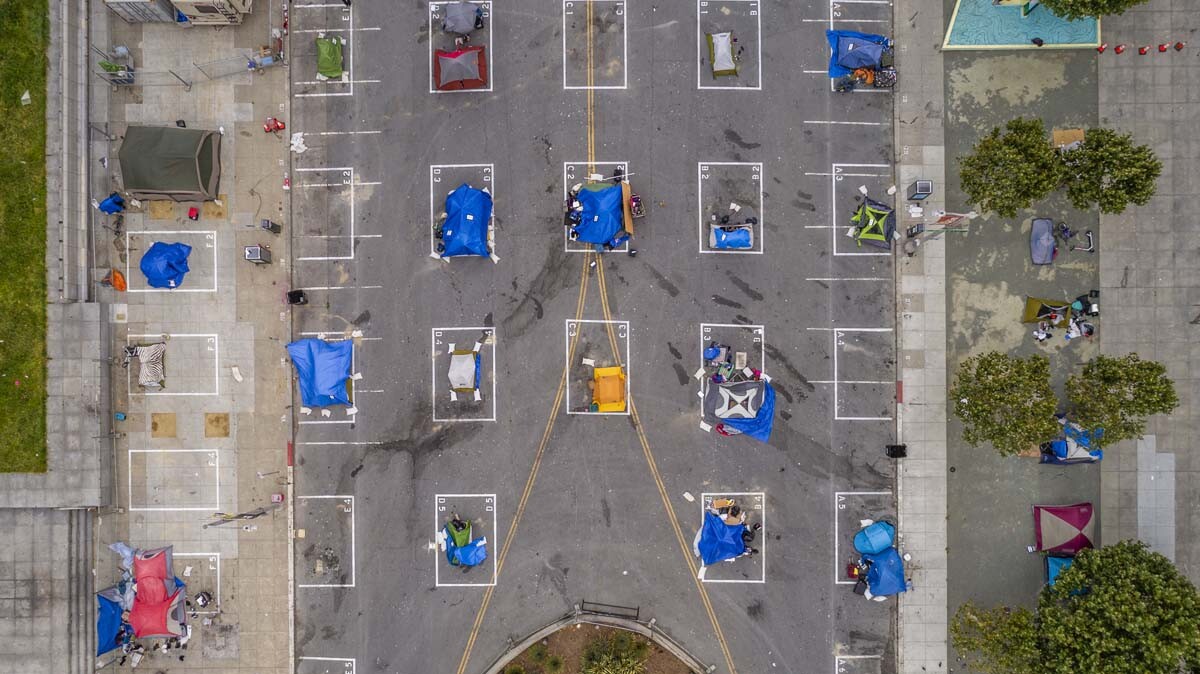 An encampment of homeless at a parking lot | iStock