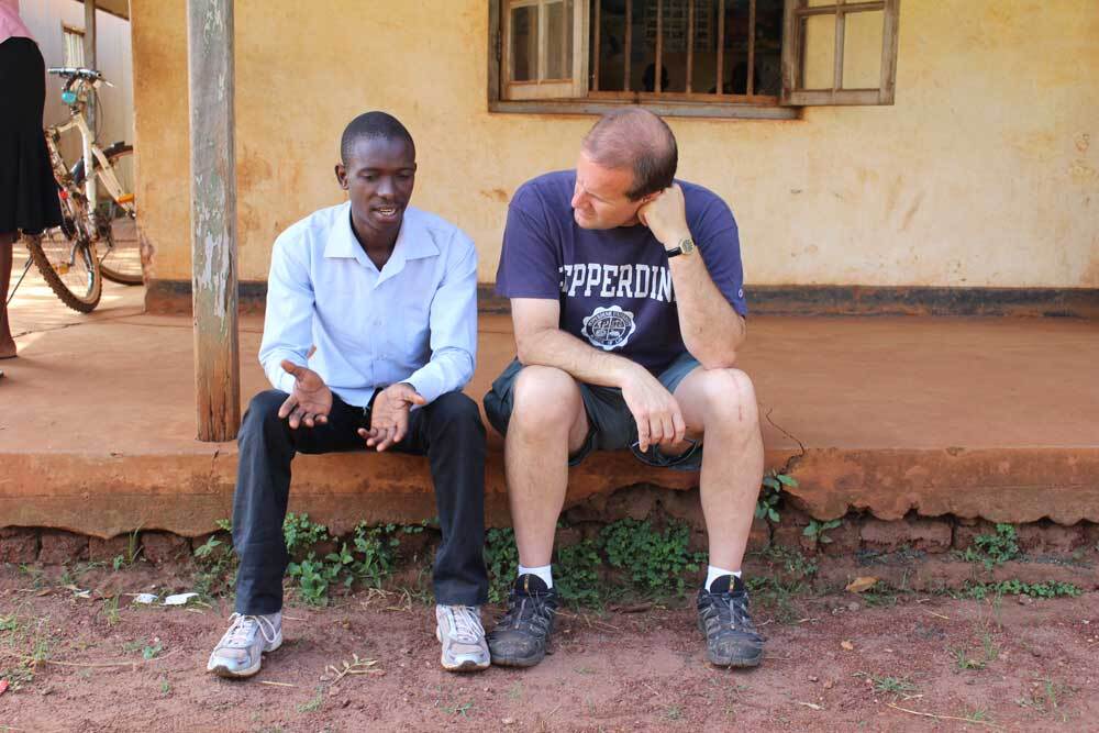Henry (left) and Jim (right) chat in Uganda. | "Remand"