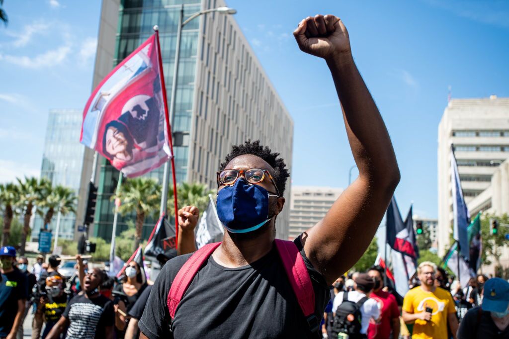 Black Lives Matter supporters march through downtown Los Angeles on the first anniversary of George Floyd's death on Tuesday, May 25, 2021.