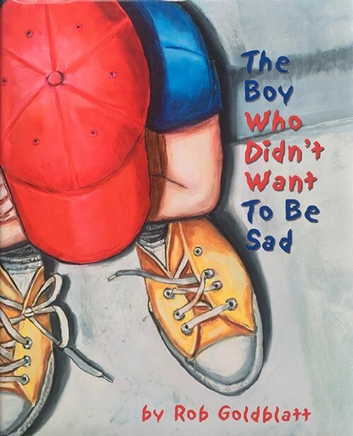 Book cover of “The Boy Who Didn’t Want to Be Sad” written and illustrated by Rob Goldblatt featuring an illustration of a little boy looking down at his sneakers. | Courtesy of Amy Monn