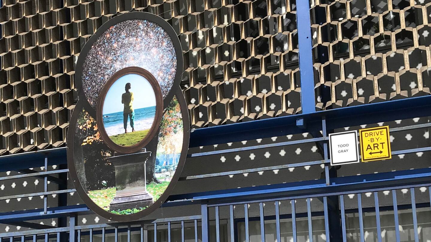 Todd Gray's juxtaposition of a dark-skinned boy atop a pedestal with the cosmos over his head on Crenshaw Boulevard in Leimert Park. | Carol Cheh