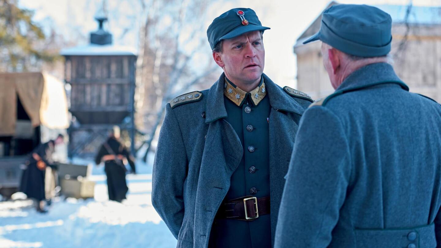 An officer speaks to a civilian.