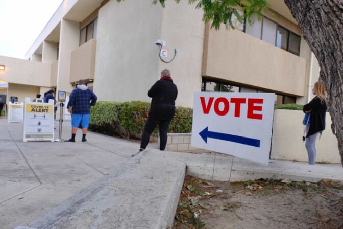 People wait in line to vote at the O.C. Registrar. | Chava Sanchez/LAist