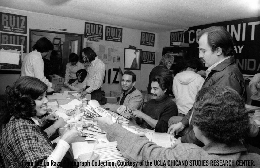 CSRC_LaRaza_B14F5S2_N001 Raul Ruiz and others fold campaign pamphlets | Manuel Barrera, Jr. La Raza photograph collection. Courtesy of UCLA Chicano Studies Research Center