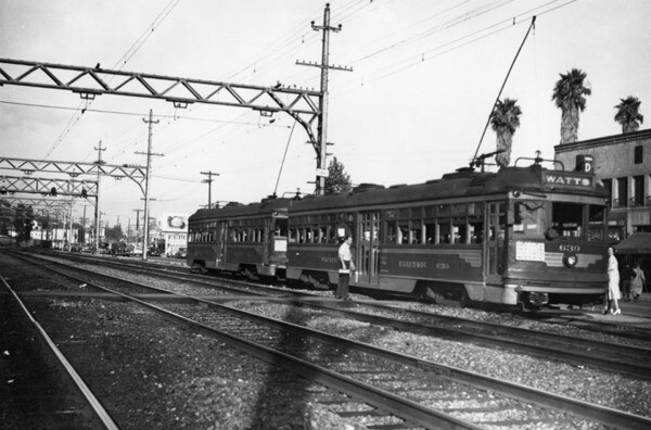 A man waiting to board a waiting Pacific Electric car at the Watts station circa 1940s | Security Pacific National Bank Collection, Los Angeles Public Library