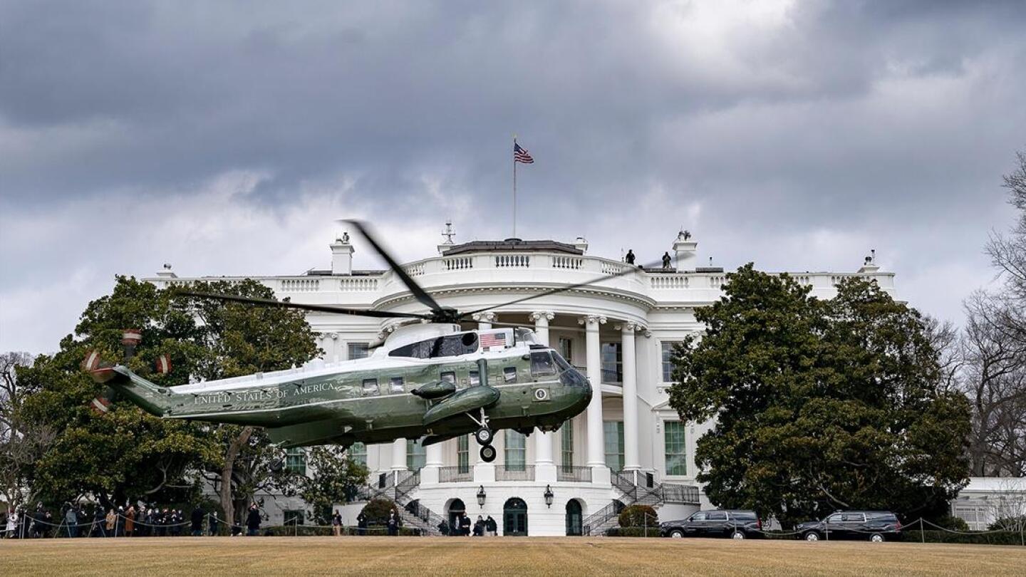 A helicopter landing in front of the White House.