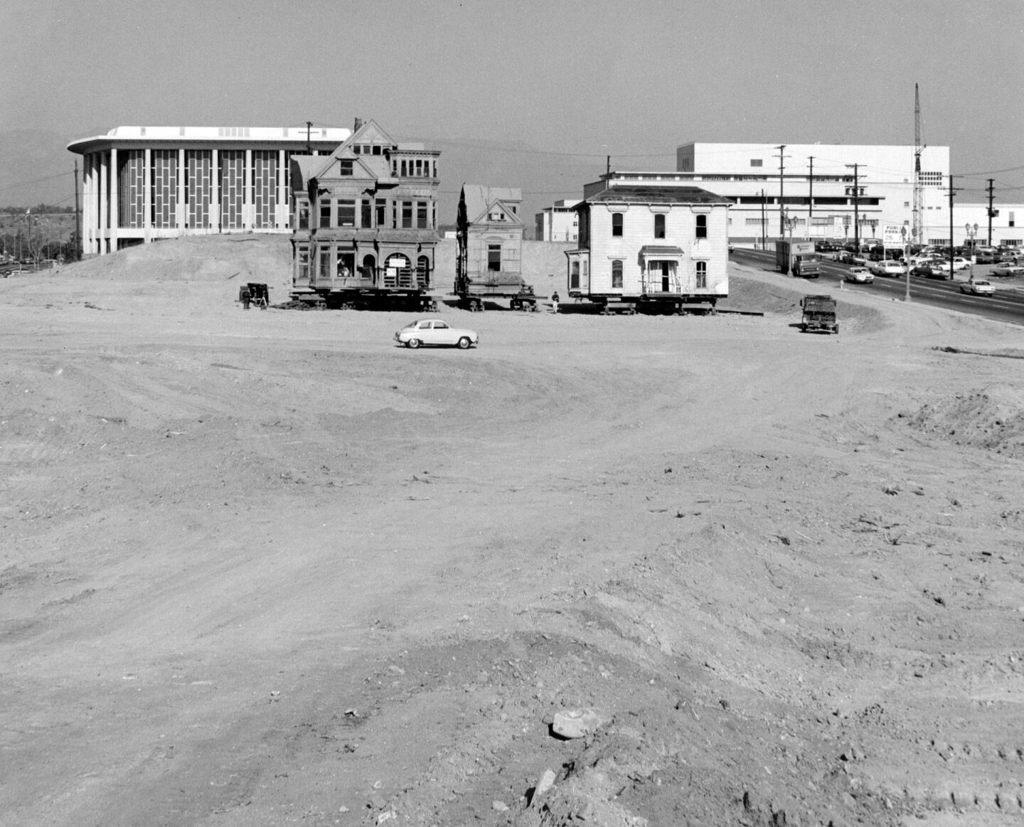 Two remnants of Bunker Hill, their surroundings completly transformed by regrading, prepare for relocation. Courtesy of the Security Pacific National Bank Collection - Los Angeles Public Library.
