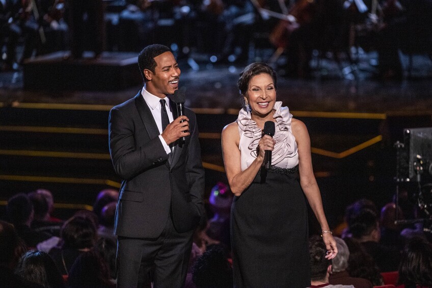 An African American man and a Latina woman are emcees at the annual holiday show.