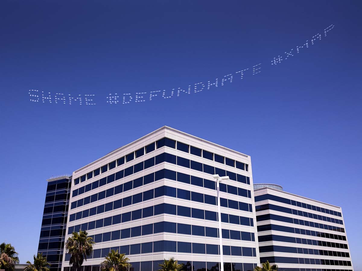 "SHAME #DEFUNDHATE #XMAP" written in in the sky, contributed by Cassils over the Geo Group Headquarters. The company is one of the largest operators of adult detention centers for ICE.| William Camargo, In Plain Sight