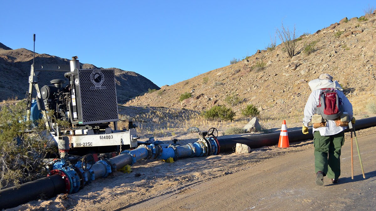 Edie Harmon looks at the water pipeline and pump station along the road into Skull Valley. | Nick Morales