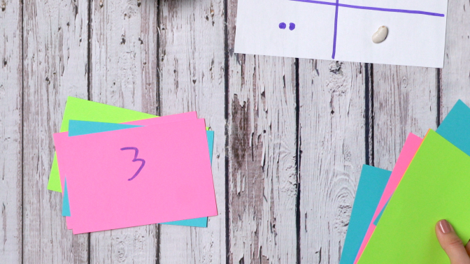 a colorful index card with the number three written on it.
