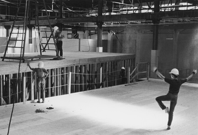 Worker dancing on stage. | Photo: Grant Mudford.