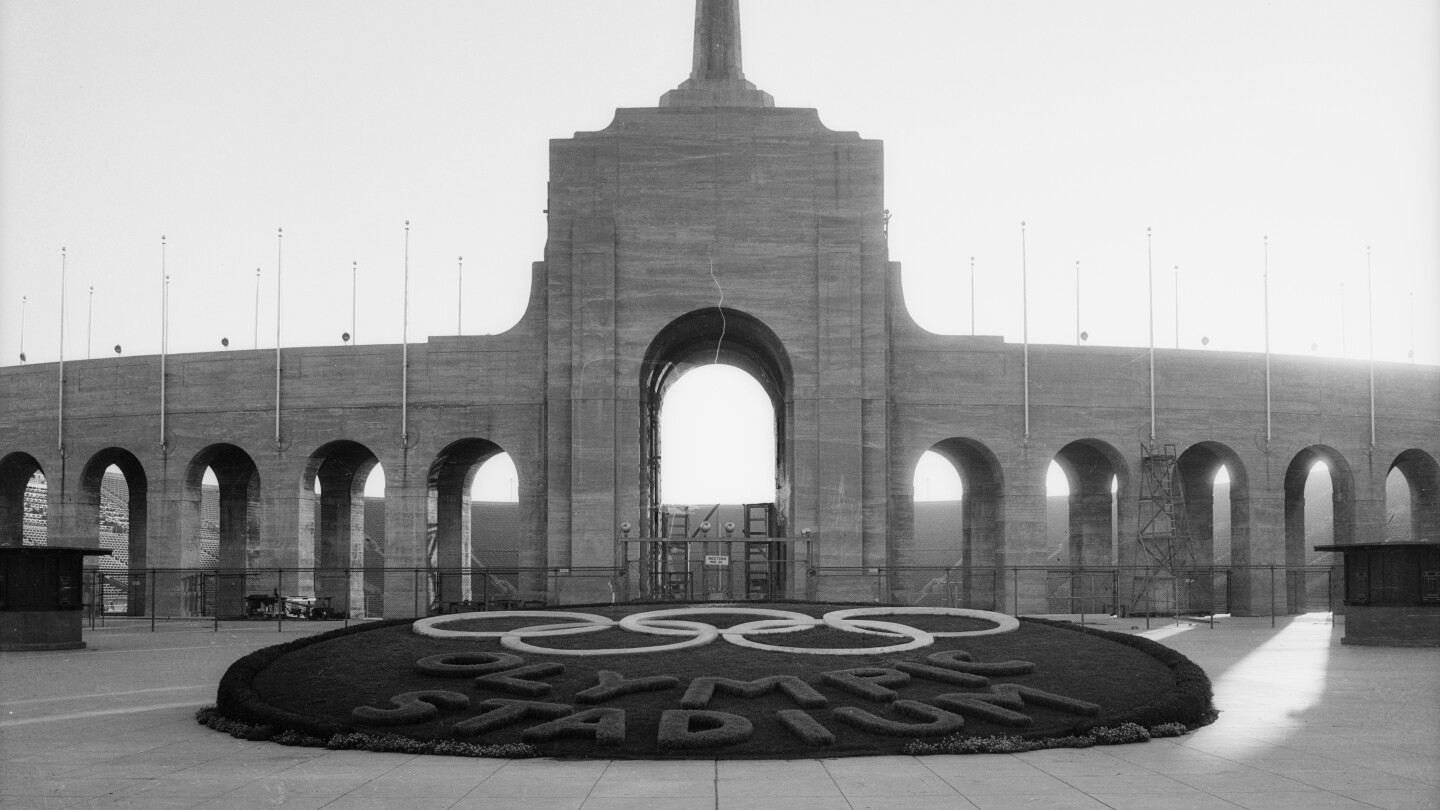 The Coliseum during the 1932 Olympics in Los Angeles shows the words "Olympic Stadium" on the foreground.