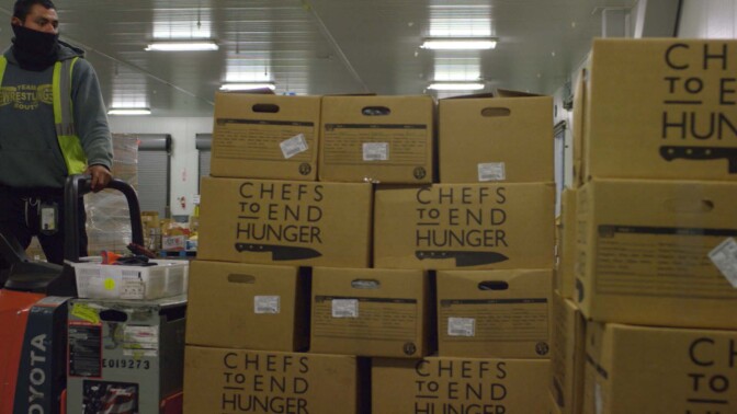 Boxes of recovered food donated by restaurants and hotels to Chefs to End Hunger. | Still from "Broken Bread"