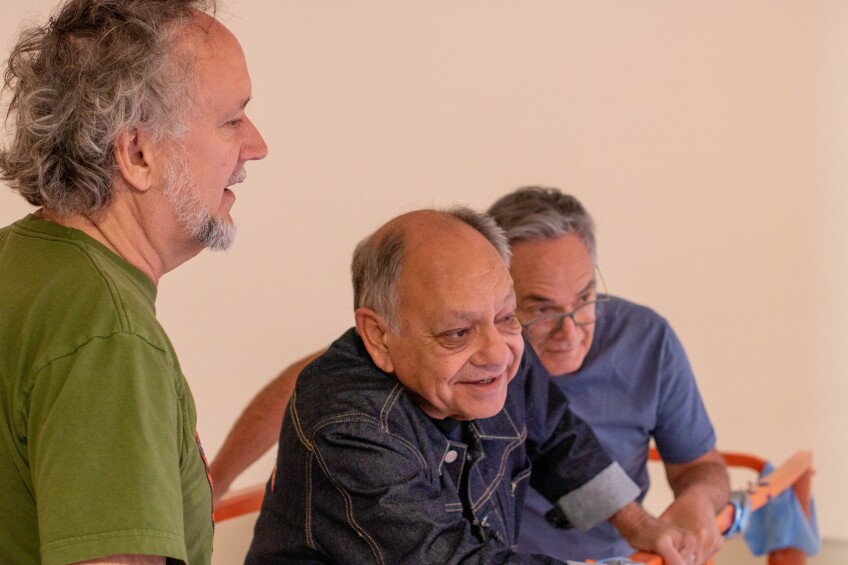 Cheech Marin looks on with interest at artwork